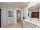 This bathroom features a single sink vanity, a decorative sliding door, and neutral tile flooring at 6664 Kara Ln, Brownsburg, IN 46112