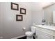 Cozy half bathroom with a modern vanity, decorative artwork, and updated fixtures at 6664 Kara Ln, Brownsburg, IN 46112