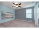 This cozy bedroom offers a ceiling fan and a modern accent wall, creating a serene and stylish space at 6664 Kara Ln, Brownsburg, IN 46112