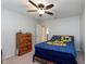 Bedroom featuring ceiling fan, blue bedding, and a wooden dresser; natural light and a neutral color palette at 6664 Kara Ln, Brownsburg, IN 46112