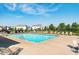 Inviting community pool with lounge chairs, surrounded by well-maintained landscaping and residential homes at 6664 Kara Ln, Brownsburg, IN 46112