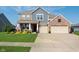 Inviting two-story home featuring brick accents, a well-manicured lawn, and a two-car garage at 6664 Kara Ln, Brownsburg, IN 46112