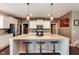 Spacious kitchen with a large island, granite countertops, white cabinets, and stainless steel appliances at 6664 Kara Ln, Brownsburg, IN 46112