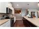 Kitchen featuring stainless steel appliances, an island with granite countertops and wood floors at 6664 Kara Ln, Brownsburg, IN 46112