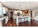 Bright kitchen featuring an island with bar stools, granite counters, and stainless steel appliances at 6664 Kara Ln, Brownsburg, IN 46112