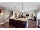 An open kitchen featuring an island with granite countertops and hardwood floors at 6664 Kara Ln, Brownsburg, IN 46112