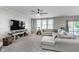 Bright and airy living room featuring a modern ceiling fan and a view to the back yard at 6664 Kara Ln, Brownsburg, IN 46112