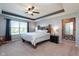 Relaxing main bedroom with a large window, a ceiling fan, and a rustic wooden bed frame at 6664 Kara Ln, Brownsburg, IN 46112