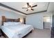 This main bedroom offers a rustic wooden bed frame, a ceiling fan, and easy access to a walk-in closet at 6664 Kara Ln, Brownsburg, IN 46112