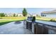 Outdoor kitchen featuring a built-in grill, countertop space, and fire pit at 6664 Kara Ln, Brownsburg, IN 46112