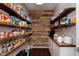 Walk-in pantry with custom wood shelves and storage, providing ample space for kitchen essentials at 6664 Kara Ln, Brownsburg, IN 46112