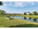 Scenic view of the neighborhood pond, well-manicured lawns, and lush landscaping at 6664 Kara Ln, Brownsburg, IN 46112