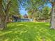 Large, grassy backyard shaded by mature trees offering a serene outdoor space for recreation and leisure at 6739 Westdrum Rd, Indianapolis, IN 46241