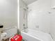 Bathroom with a toilet and a shower-tub combo featuring white tiles at 6739 Westdrum Rd, Indianapolis, IN 46241
