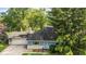 Blue ranch-style home with stone accents, a front lawn, and mature trees at 6739 Westdrum Rd, Indianapolis, IN 46241