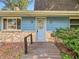 Charming front entrance featuring stone accents, a wooden walkway, and a well-maintained front door at 6739 Westdrum Rd, Indianapolis, IN 46241