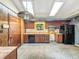 Functional kitchen featuring classic wood cabinets, a skylight, and black appliances, ideal for home-cooked meals at 6739 Westdrum Rd, Indianapolis, IN 46241