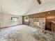 Spacious living area featuring a stone fireplace and ample windows, creating a warm and inviting atmosphere at 6739 Westdrum Rd, Indianapolis, IN 46241