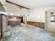 Bright, open-concept layout with stone fireplace and seamless flow from the living area into the kitchen at 6739 Westdrum Rd, Indianapolis, IN 46241
