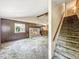 Spacious living room features stone fireplace, vaulted ceilings, and stair access to the upper floors at 6739 Westdrum Rd, Indianapolis, IN 46241