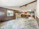 Open living room with vaulted ceilings, stone fireplace, and view into the kitchen, perfect for entertaining at 6739 Westdrum Rd, Indianapolis, IN 46241