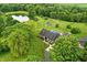 Aerial view of the property featuring a pool, pond, and various outbuildings at 750 N 500 W, Lebanon, IN 46052