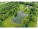 Stunning aerial view of a pond, mature trees and the backyard pool area at 750 N 500 W, Lebanon, IN 46052
