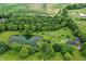 Stunning aerial view of estate with pool, pond with dock, barn and pastures, surrounded by mature trees and lush greenery at 750 N 500 W, Lebanon, IN 46052