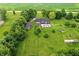 Expansive property with a pool and outbuildings, surrounded by a beautiful lawn and greenery at 750 N 500 W, Lebanon, IN 46052