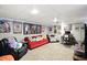 The finished basement area is decorated with posters, a red couch, and fun, colorful themes at 750 N 500 W, Lebanon, IN 46052