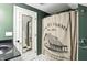 The bathroom features a farmhouse shower curtain, a marble countertop, and mosaic tile floors at 750 N 500 W, Lebanon, IN 46052