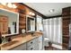 Bathroom with a double vanity, wood paneling, and a shower with a curtain at 750 N 500 W, Lebanon, IN 46052