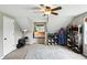 This bedroom offers sloped ceilings, a ceiling fan, ample shelving, and natural light from a window at 750 N 500 W, Lebanon, IN 46052