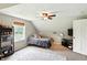 This room offers sloped ceilings, a ceiling fan, shelving, a bed, and natural light from a window at 750 N 500 W, Lebanon, IN 46052