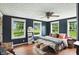 Sunlit bedroom with hardwood floors, ceiling fan, and large windows overlooking the yard at 750 N 500 W, Lebanon, IN 46052