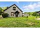 Charming home with gray siding, black trim and entry door, green yard at 750 N 500 W, Lebanon, IN 46052