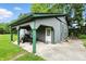 Exterior view of gray shed with green trim and covered parking at 750 N 500 W, Lebanon, IN 46052