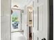 Bright hallway with white shiplap walls leading to an outdoor patio with blue seating for seamless indoor/outdoor living at 750 N 500 W, Lebanon, IN 46052