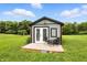 Cozy outbuilding featuring a small deck with table and chairs, surrounded by a green lawn at 750 N 500 W, Lebanon, IN 46052