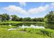 Beautiful view of a pond reflecting the sky, surrounded by lush greenery and a small boat at 750 N 500 W, Lebanon, IN 46052