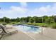 Relaxing backyard pool with lounge chairs and a view of the surrounding trees and outbuildings at 750 N 500 W, Lebanon, IN 46052