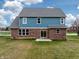 Exterior of home featuring brick and blue siding with sliding glass doors leading to the patio at 7604 Brownstone Ct, Greenfield, IN 46140
