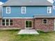 Exterior of home featuring brick and blue siding with sliding glass doors leading to the patio at 7604 Brownstone Ct, Greenfield, IN 46140