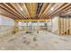 Unfinished basement with concrete floor, utility hookups, and exposed wooden ceiling joists offers potential for customization at 7604 Brownstone Ct, Greenfield, IN 46140
