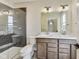 Modern bathroom boasts double sinks, a tiled shower with glass door, and updated fixtures at 7604 Brownstone Ct, Greenfield, IN 46140