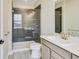 Contemporary bathroom featuring tiled shower, a single sink with a vanity, and modern fixtures at 7604 Brownstone Ct, Greenfield, IN 46140