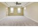 Bright bedroom featuring a tray ceiling, neutral walls, and multiple windows for natural light at 7604 Brownstone Ct, Greenfield, IN 46140