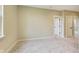 Spacious bedroom with soft carpet, neutral walls, and doorways leading to other rooms at 7604 Brownstone Ct, Greenfield, IN 46140