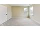 Well-lit bedroom with plush carpet and two windows offering natural light and outdoor views at 7604 Brownstone Ct, Greenfield, IN 46140
