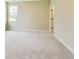 A bright bedroom with neutral walls and plush carpet, offering a cozy and inviting space at 7604 Brownstone Ct, Greenfield, IN 46140